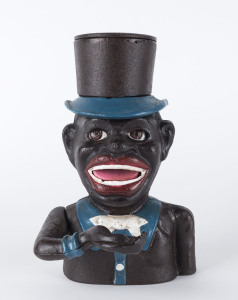 An American style cast iron money box with emblazoned title, 21cm high.