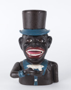An American style cast iron money box with emblazoned title, 21cm high.