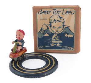 BABY TOY LAND tinplate and celluloid clockwork boy on four-wheel cart with circular metal track. In original box with top label marked "Made in Japan" circa 1950s. Box size: 16 x 16cm (6.25 x 6.25"). Provenance: Purchased June 2013, US$1085.