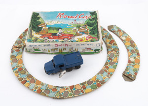 ROAD CAR Japanese wind-up tinplate toy in original colourful box. The toy consists of a blue wind up pick-up truck (shown in the distance on the boxlid) and 5 curved sections of track. The cardboard track pushes together on the ends with some brass sleeves. With original key. Maker unknown., circa 1960. Box size: 21 x 13.5cm. (8.25 x 5.25").