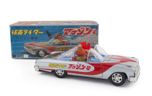 MASKED KAMEN RIDER in Ford Galaxy Tin-plate friction-powered car by AOSHIN TIN TOYS, Japan, circa 1970; in original box. Friction drive produces distinctive LOUD clicking noise. Length: 25cm (10"). Rare in this condition and with box.