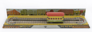 Tin-plate lithographed wind-up trolley car on track with city-scape backdrop; by Modern Toys / Masudaya, 1950s. Length (of track): 23.5cm (9.25").