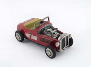 HOT ROD "CENTURY" friction driven tinplate car with piston action by Nomura (T.N. in diamond); rubber wheels, circa 1960s. Length: 18.5cm (7.25").
