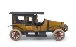 Large tinplate windup yellow & black taxi-cab with uniformed driver in outside compartment; two headlamps, two opening dorrs, both with "J.D.P." insignia; spoked metal wheels; probably French, circa 1920s. Length: 28cm (11").