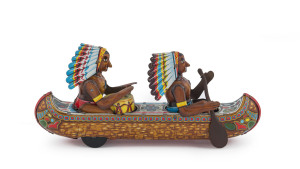 American Indians in a tinplate lithographed friction-driven canoe by MASUYA, Japan, circa 1960. The front Indian rows while the rear Indian plays the tom-tom. Length: 25cm (10").