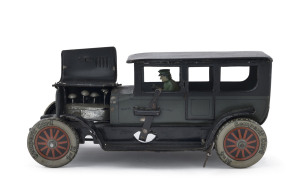 GAMA/MOKO tinplate windup limousine with uniformed driver, 4 cylinder engine with moving pistons, Semperit Cord marked metal wheels, gull wing hood, internal key, with forward and reverse setting lever next to the driver. circa 1920s. Length: 20.5cm (8").