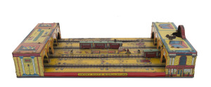 GRAND CENTRAL STATION by Henry Katz,circa 1920s lithographed tin, two oval tracks on table top toy with two three-carriage trains, key wind operated. Dimensions: 41 x 20cm (16 x 8").