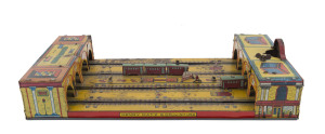 GRAND CENTRAL STATION by Henry Katz,circa 1920s lithographed tin, two oval tracks on table top toy with two three-carriage trains, key wind operated. Dimensions: 41 x 20cm (16 x 8").