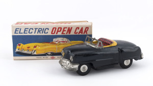 1950s convertible black Cadillac in original box "ELECTRIC OPEN CAR" by KKK, Japan; tinplate, battery driven, rubber tyres, steering wheel and on/off switch on dashboard. Length: 18cm (7").