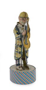 DISTLER GUITAR PLAYER, Germany, clockwork toy, lithographed in tin, full clown figure stands on round base with concealed clockwork, sounds are emitted when wound. Height: 22cm (8.5"). 
