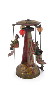 Vintage tinplate lithographed wind-up carousel with three boys riding in the gondolas around the central tower; each rider intersperced with a celluloid ball. The base decorated with children holding hands. Marked "Made in Japan". Height: 23cm (9").
