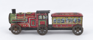 Vintage locomotive and passenger carriage combined on one metal platform with six wheels; tinplate lithographed; the loco marked "JAPAN 1", the carriage numbered "5962". Unknown maker. Length: 23cm (9").