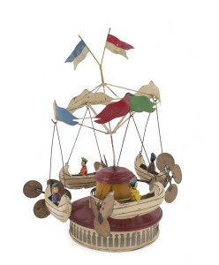 Vintage Bing/Muller & Kader (Germany) tinplate handpainted Carousel Riders in Flying Boats with four 4 boys riding in the boats which have large propellors mounted at the stern. The integrated keywind mechanism works well with the boats lifting away from the centre under the colourful flags and banners. Circa 1900s. Height (to top of flag): 35cm (14").