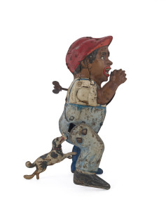 Vintage Gunthermann "Poor Pete" tinplate windup lithographed toy which makes fun of a black boy being bitten on his behind by a small spotted dog. Poor Pete tries to run away but the dog won't let go! Height: 16.5cm (6.5").