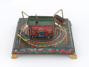 Tin-plate lithographed table-top railway station with two clockwork driven trains rotating around the central building; a bell rings while they are in motion. Japan, circa 1950s. Dimensions: 16 x 16cm (6.25").