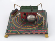 Tin-plate lithographed table-top railway station with two clockwork driven trains rotating around the central building; a bell rings while they are in motion. Japan, circa 1950s. Dimensions: 16 x 16cm (6.25"). - 2