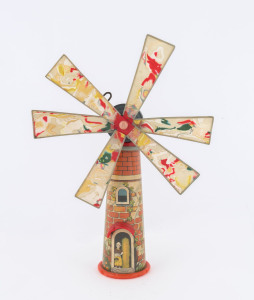 Wind-up Windmill with celluloid blades and a little dutch girl looking out from the door; made in Japan by Kuramochi, with the distinctive "C.K. in a diamond" trademark. Height: 33cm (13").