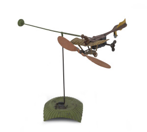 DISTLER circling aeroplane on base. An antique tinplate toy monoplane with wing mounted pilot and clockwork driven propellors able to fly around base and roll as it makes a circling motion. Height: approx. 23cm (9"). Extremely rare, we have found only one