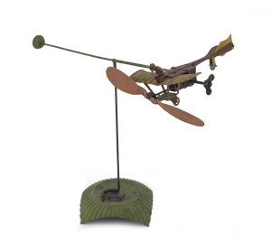 DISTLER circling aeroplane on base. An antique tinplate toy monoplane with wing mounted pilot and clockwork driven propellors able to fly around base and roll as it makes a circling motion. Height: approx. 23cm (9"). Extremely rare, we have found only one other example offered at public auction in the last 10 years.