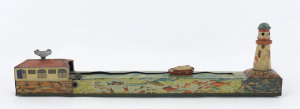 A tinplate wind-up lithographed version of a boat being guided to port by a lighthouse, made by Masudaya (M.T.), Japan, but based on the popular pre-war version by Arnold. Length: 38cm (15").
