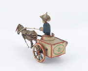 GERMAN LITHOGRAPHED TIN TOY "NA-NU" BY LEHMANN Pulling a two-wheeled cart with red trim is a curious animal, the zebra-horse cross-breed Zebroid. A man with blue shirt, brown pants and tall hat is seated on the cart. When the coil - spring is wound, the z - 2
