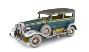 A FRANKLIN TWO DOOR SEDAN by NOMURA, JAPAN. A very scarce pre-war lithographed tin automobile with electric head lights, done in blue body, yellow trim, brown roof, features spare wheel on running board, red light at rear, clockwork driven, reads, "Frankl
