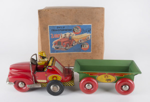 LION CHILD TRANSPORTATION TRUCK and TRAILER, made by Marusan Japan (marked SAN under trailer), unusual right hand drive cab with wagon style trailer and driver in position. Both sections with oval logo "CHILD TRANSPORTATION WEST - USA CO. TEL. 5113". When connected, Length: 47cm (18.5"). Contained in original box with top label, dated "1953".