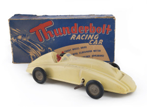 "Thunderbolt Racing Car" wind-up toy made from cream-coloured "duperite" plastic by Moulded Products (Australasia) Ltd, streamlined appearance with front wheel drive; at least one wheel replaced, mechanism not operating, comes with original box; length (of car) 33cm (13½"); box 34cm (13¾"). Rare.