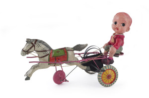 Celluloid boy riding behind a tinplate wind-up trotter, Japan, circa 1940s in overall superb condition. Length: 24cm (9.5").Provenance: This piece was sold on eBay in April 2013. The advertised price was US$3,500.