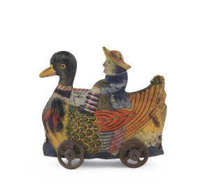 Lithographed tinplate Dutch person riding on a wheeled duck, marked "Made in Japan"; very early. [See Kitahara & Shimizu, "1000 Tin Toys" page 279]. Length: 9cm (3.5").