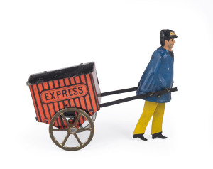 LEHMANN "EXPRESS" PORTER, Germany, lithographed tinplate, depicts full figure porter pulling an enclosed cart marked "Express", spoke wheels. Length: 15cm (6"). This is the flywheel version, that acts as a friction mechanism, when the knob is spun it will go forwards or backwards, across a smooth flat surface, the porter's legs move, but not much.