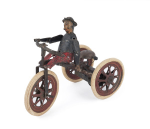 Very early tinplate painted man on tricycle; original rubber tyres on spoked wheels marked "Suzukan Mfg Co. Made in Japan"; with clockwork mechanism and bell mounted on rear axle. Length: 20cm (8").