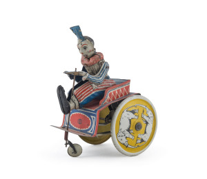 1920's Greppert & Kelch "G+K" brand circus clown on cart, mechanical tin lithographed wind-up toy, No. 504. Made in Germany, with elephants on the wheels. Height: 15cm (6").