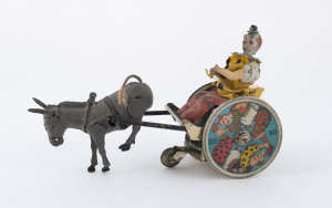 Pre-war Lehmann, c1910 wind up toy "The Balky Mule" featuring a clown with cart & uncooperstive mule; very colourful lithographed wheels marked "LEHMANN GERMANY" and with 1907 U.S. Patent notice. Length: 20cm (8").