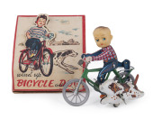 BOY ON BICYCLE WITH DOG, charming lithographed tinplate, rubber and plastic wind-up toy, in the original box by ICHIMURA, Japan (with Indian head with headdress logo). Height of box: 14cm (5.5").