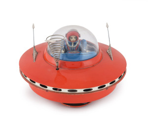 YOSHIYA SKY PATROL FLYING SAUCER circa 1965When it hits an object, the beautifully lithographed female astronaut/pilot moves the levers and steers her flying saucer in a new direction. "K.O." in a diamond trademark on the back of the seat. Battery operate
