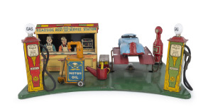 MARX Roadside Rest Service Station, circa 1930s, battery powered and complete with working car lift, blue car, all pumps with hoses attached, and rare water backet, which is so often absent. Width: 34.5cm (13.5").