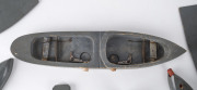 Scratch built "exploding" wooden battleship made up of nine parts, plus two submarines with wooden torpedoes, two target points on the battleship triggering the mouse-trap mechanism when hit by the torpedoes, circa 1920s. Length 38cm (14.75"), width 8cm ( - 2