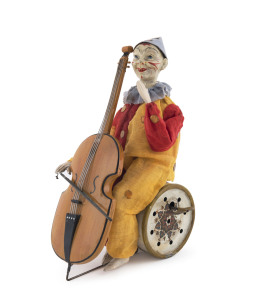 CLOWN PLAYING CELLO, Germany, attributed to Gunthermann, the clown seated on painted tin drum with clockwork plink-plink music, cast metal cello, hand painted composition head, original clothes w/lace trimmed collar and clown's traditional garb, moves arm