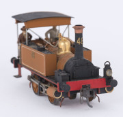 1879 I Class tank engine, road number '48' (80x33x40mm) built by Neilson & Co (Glasgow, Scotland), yellow-brown livery with gold plated trim, 0-4-0 wheel configuration, also a wagon loaded with aggregate, and an unfinished wagon. (3 items) - 3