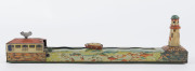 A tinplate wind-up lithographed version of a boat being guided to port by a lighthouse, made by Masudaya (M.T.), Japan, but based on the popular pre-war version by Arnold. Length: 38cm (15"). - 2