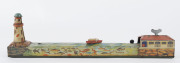 A tinplate wind-up lithographed version of a boat being guided to port by a lighthouse, made by Masudaya (M.T.), Japan, but based on the popular pre-war version by Arnold. Length: 38cm (15"). - 3