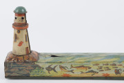 A tinplate wind-up lithographed version of a boat being guided to port by a lighthouse, made by Masudaya (M.T.), Japan, but based on the popular pre-war version by Arnold. Length: 38cm (15"). - 4