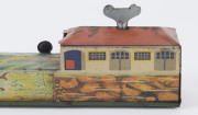 A tinplate wind-up lithographed version of a boat being guided to port by a lighthouse, made by Masudaya (M.T.), Japan, but based on the popular pre-war version by Arnold. Length: 38cm (15"). - 5