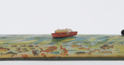 A tinplate wind-up lithographed version of a boat being guided to port by a lighthouse, made by Masudaya (M.T.), Japan, but based on the popular pre-war version by Arnold. Length: 38cm (15"). - 6