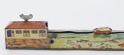 A tinplate wind-up lithographed version of a boat being guided to port by a lighthouse, made by Masudaya (M.T.), Japan, but based on the popular pre-war version by Arnold. Length: 38cm (15"). - 8