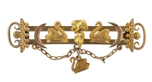 CHARLES HENRY MAY Western Australian goldfields brooch showing swans and crescents flanking a natural nugget specimen with swan pendant drop lower centre, stamped "18ct", 5.5cm long, 6.4 grams