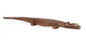 A fine carved wooden crocodile ornament with shell eyes, Papua New Guinea, 20th century