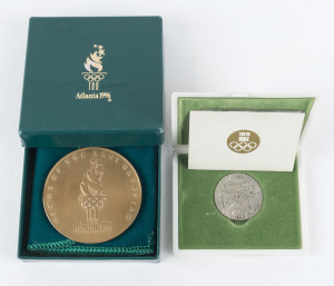 TOKYO 1964 silver medal in original plastic presentation case issued by The Tokyo Olympic Fund Raising Association, 30mm diameter; also, a 1996 Atlanta Participation Medal in original box. (2 items).