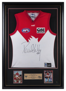 PAUL KELLY (Sydney Swans): AFL limited edition framed & glazed display, commemorating his 200th game, with signed guernsey and two inset photographs of Kelly and a plaque, numbered 56/200, overall 76x107cm.